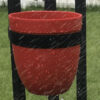 Red plastic pot in the rain. Shows it is weatherproof.